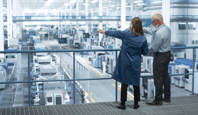 Two people in a manufacturing facility.